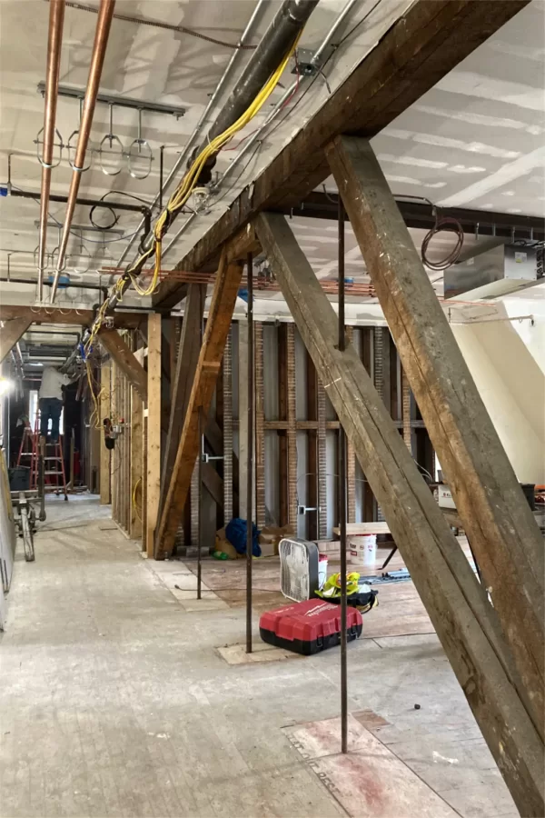 These century-old wooden trusses on the second floor, and others downstairs, will be left partially exposed as a reminder of Chase Hall's history. (Doug Hubley/Bates College)