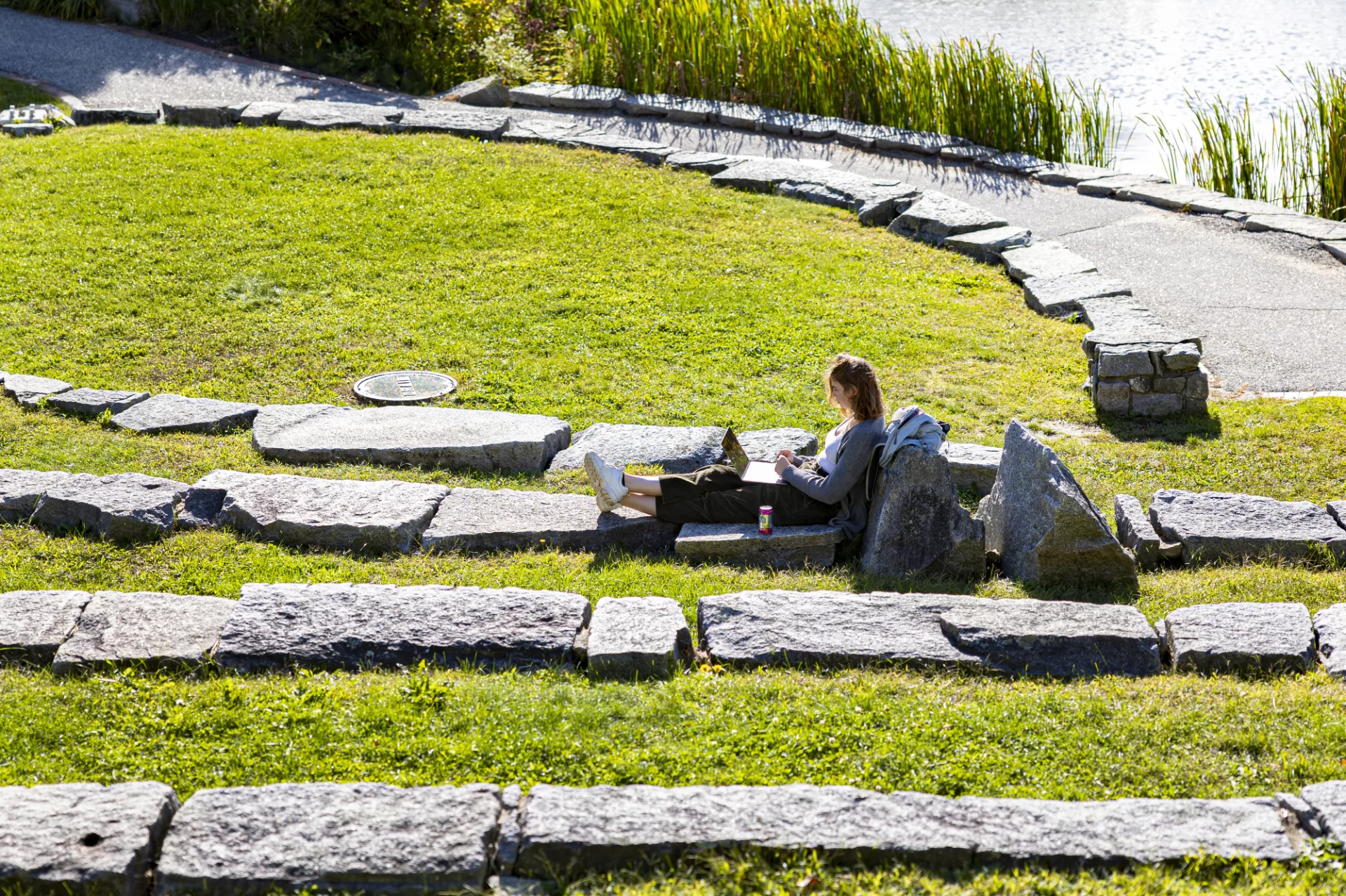 Technically it's still summer, as the fall equinox doesn't actually arrive until tonight, Sept. 21, 2022, at 9:04 p.m. EDT in the Northern Hemisphere.

As far as Sophia Cattalani '25 of Skaneateles, N.Y,, is concerned, it's summer's last hurrah.

Seated on the Keigwin Amphitheater, Cattalani was at work on an assignment for her Spanish class in "Race and Nation in the Ibero/American World" taught by Assistant Professor of Spanish Stephanie Pridgeon.

"It's probably one of the last sunny and warm days for a while," she said. "She wanted to enjoy a Puddle-side study session while she still could. "Before the whole thing is covered in snow."