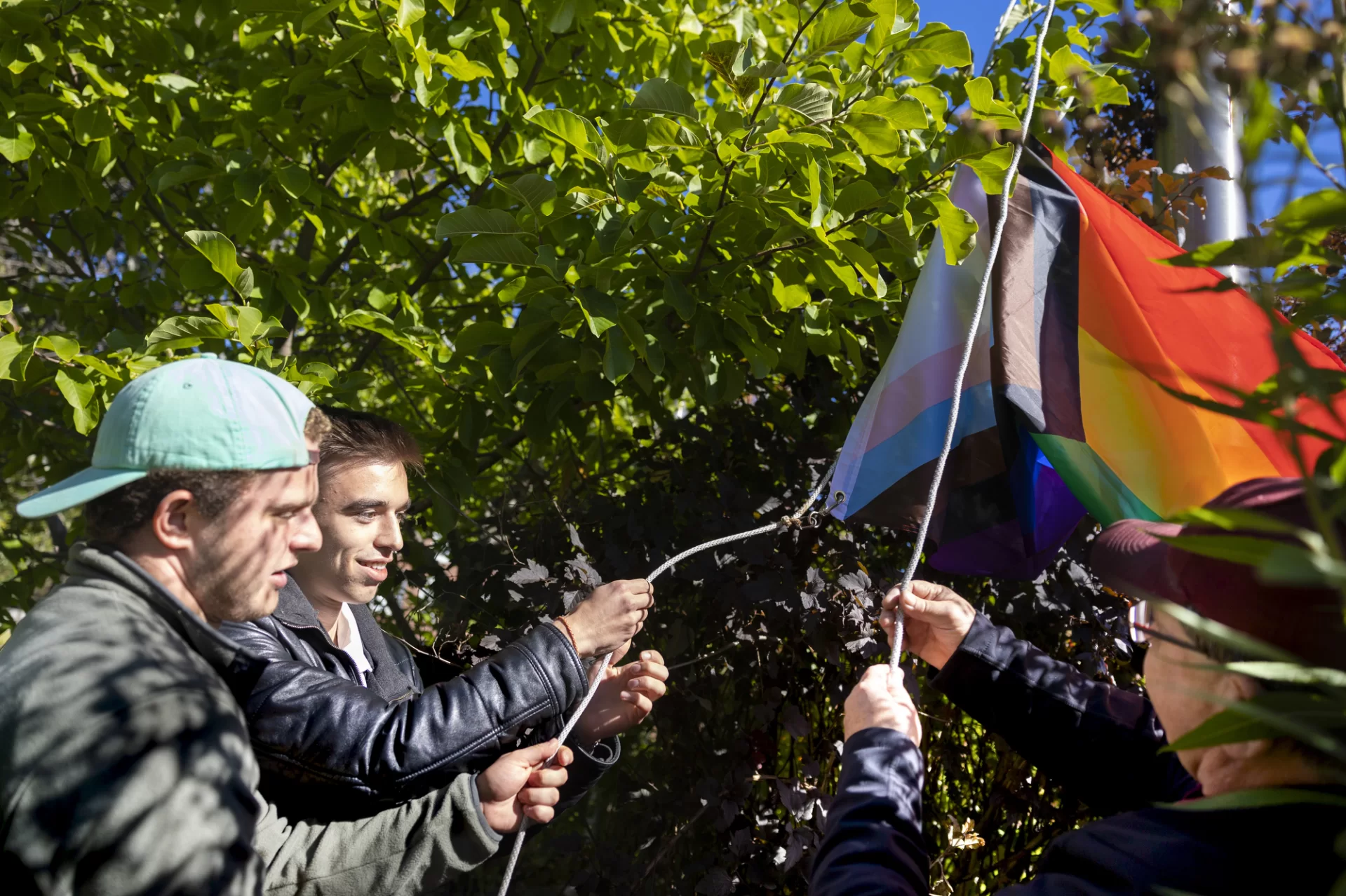 "Visibility is my method of reclaiming my authentic identity and gaining confidence and pride in it."
 
— SPARK Peer Mentor Ruslan Peredelskyi '25 of Donetsk, Ukraine, (center) raising the Progress Pride Flag at the Garcelon Field Flag Pole with Mason Bunker '23, also a SPARK Peer Mentor, and campus safety office Jim Miclon.
 
Assistant Dean for LGBTQ+ Programs with the Office of Intercultural Education Dri Hubner conceived of the idea of raising the flag for Coming Out Week. A Bates crowd watched and cheered as Huber and Peredelskyi spoke to those who gathered.
 
"This is finding freedom after years of hiding who I really am from my family and friends," Peredelskyi said. He called the flag raising an opportunity to remember members of the LGBTQIA+ community who fought for freedom and an opportunity to advocate now.
 
“This is a privilege, as my friends who stayed in Ukraine do not have the opportunity to come out without risking their security,” he said. “Coming Out Week is here to remind us about liberty to be seen and heard, and propels us to embrace it to fight inequailty and discrimination that still exists around the globe."
 
SPARQ is a network of resources sponsored by the OIE that strive to support students’ positive development of gender, (a)sexuality, and (a)romantic identity. The network offers peer mentoring, ally education, and targeted programming focused on specific LGBTQ+ identities accessible to the entire Bates community. Through these resources, SPARQ will provide a consistent presence which aspires to foster a true sense of safety for LGBTQ+ and questioning students.
 
(Phyllis Graber Jensen/Bates College) #batescollege #comingoutweek #pride #visibility