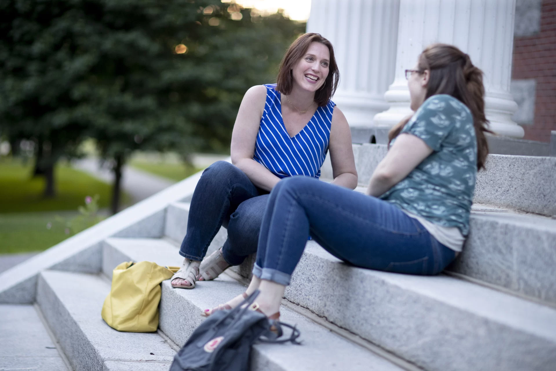 "I attribute everything to John Kelsey."
.
— It's catchup time for Lindsey Hamilton '05, director of undergraduate research at the University of Colorado, Denver, (left) and Jennifer Ambrose Lyford '04 of Durham, Maine, (right), as they reconnect on a summer evening on the steps of Hathorn Hall.
.
Hamilton, commenting on her mentor Professor Emeritus of Psychology John Kelsey, was a neuroscience major while at Bates and has returned to campus as a participant in one of several Gordon Research Conferences held at Bates each summer.
.
“My experience at Bates was so transformative as an undergraduate researcher that I want to create that opportunity for all of my Colorado students," Hamilton says.
.
"I just keep going back to my own experiences. How was I selected to do research? What were those touches that kept me involved? And now I’m trying to scale that to the University of Colorado."