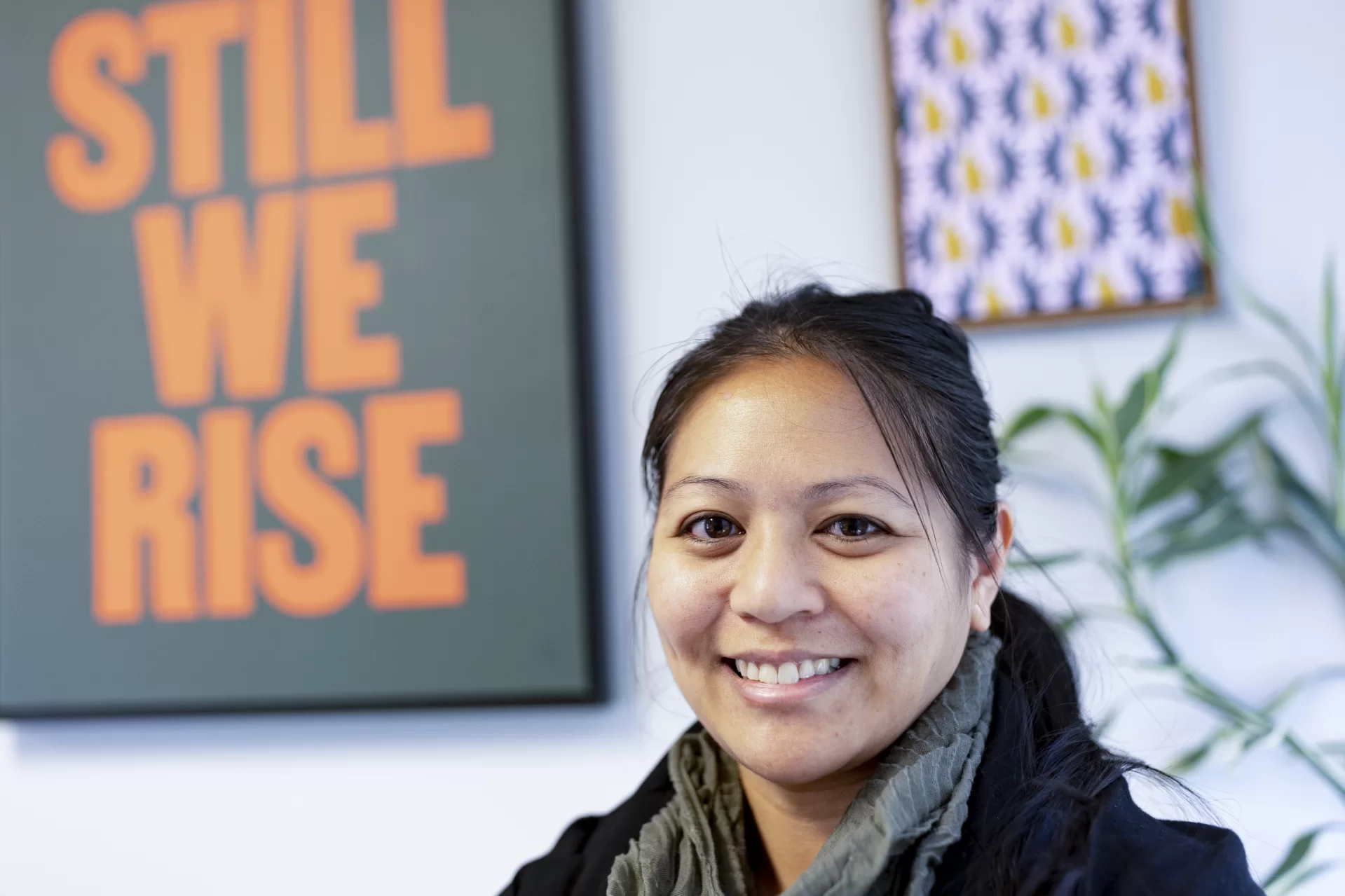 Jenna Dela Cruz Vendil Associate Director Democratic Engagement Student Activism Harward Center for Community Partnerships posing in front of the Harward Center and in her office