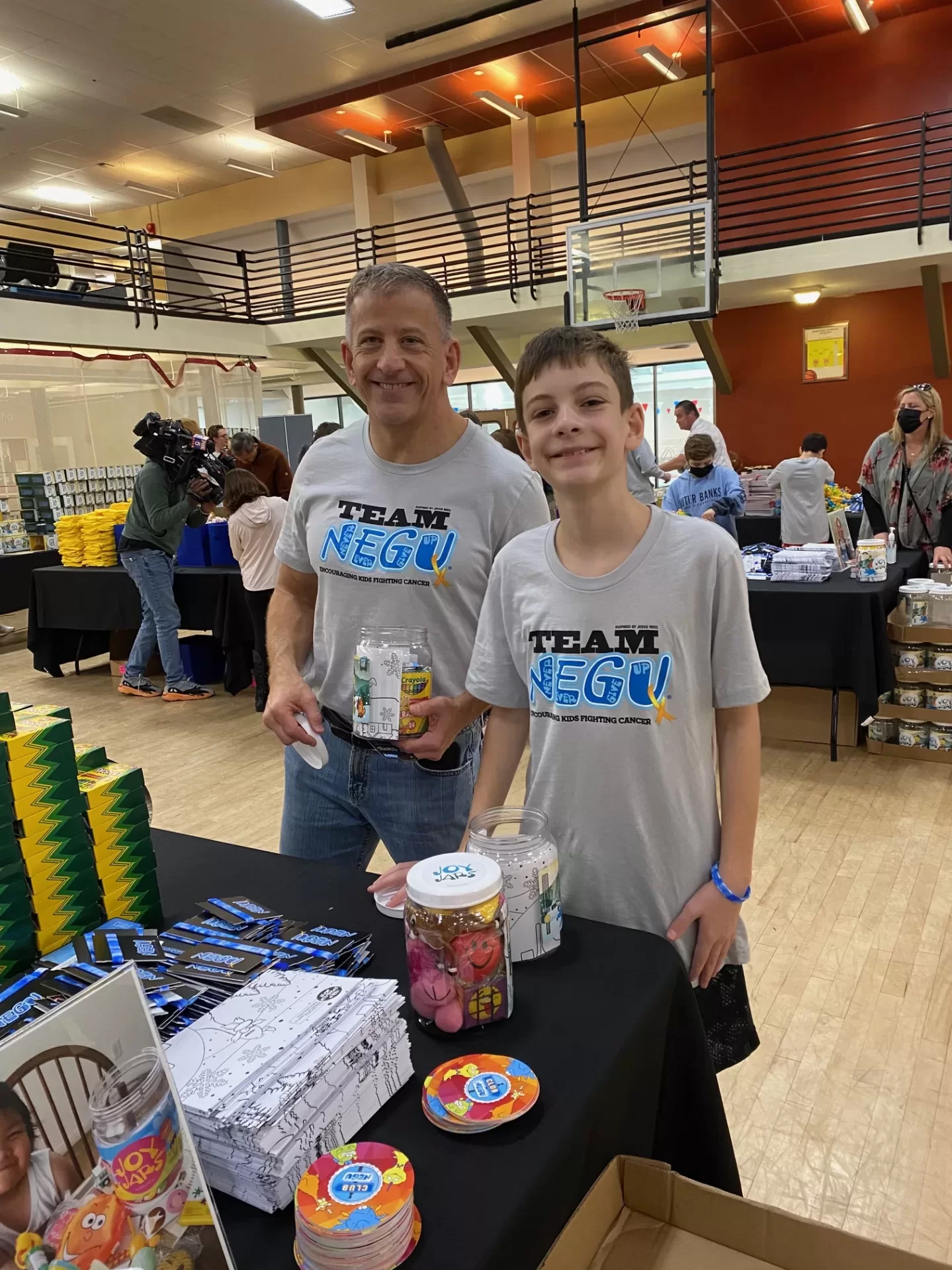 Daniel Hoffman'85 and his son, Jerron, stuffing "Joy Jars" for the Jessie Rees Foundation. Photo courtesy of Daniel Hoffman