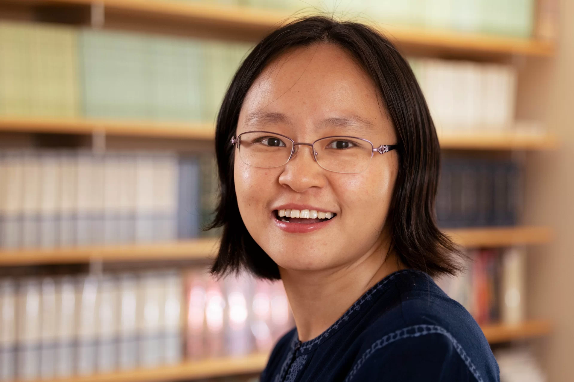 Assistant Professor of Chinese Zhenzhen Lu poses in her Roger Williams, Room 205, office.