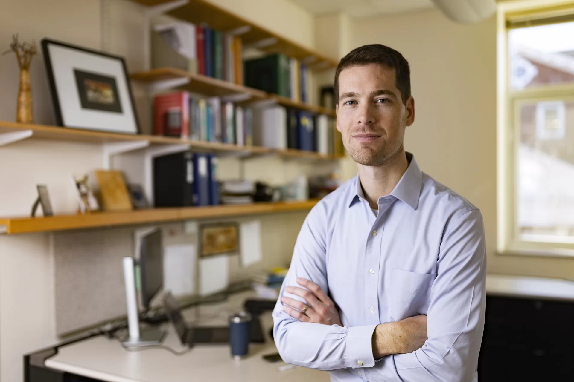 Assistant Professor of Economics Samuel Bird  poses in his Pettengill Hall Room 271office.