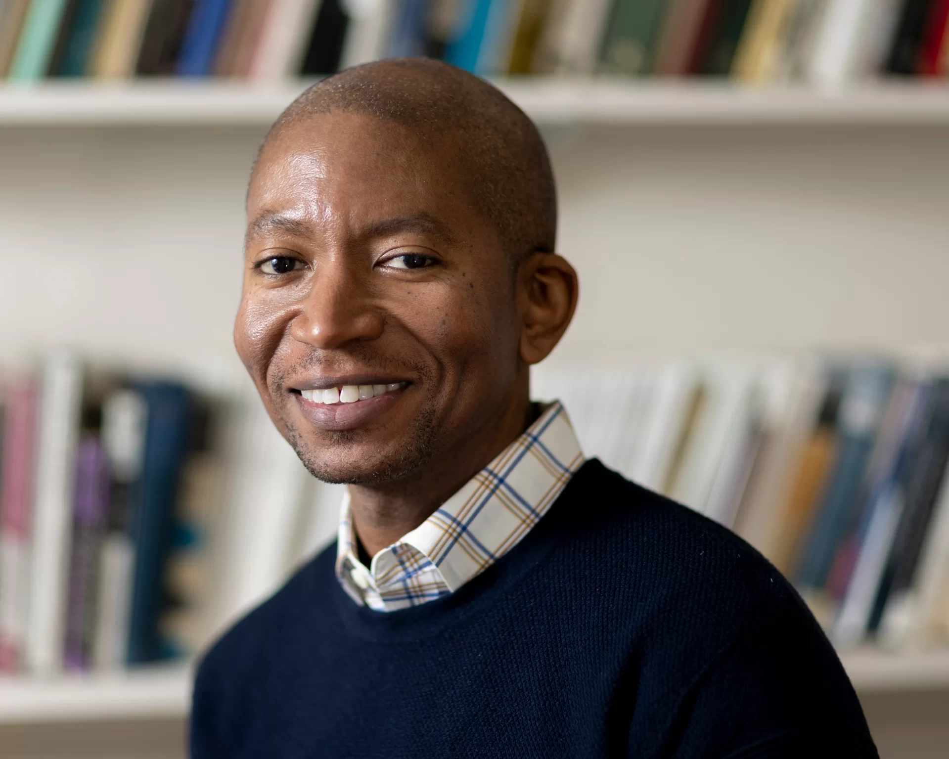 Asistant Professor of English Myronn Hardy poses for a portrait in his Hathon Hall office (Room 308), and meets with his thesis student, Alexander Tan ’23 of Hong Kong.