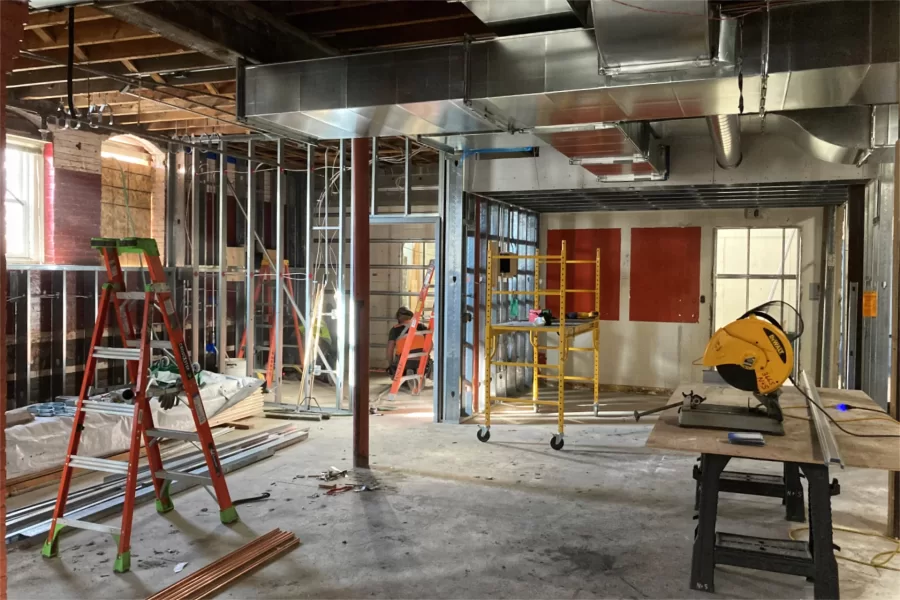 New partition walls are being placed in Chase Hall's ground-floor lobby where a campus post office and the College Store entrance were formerly found. This area will again serve as a lobby, but one more important than before: Everyone entering Chase through the western entrance off Campus Avenue will pass through here. Note the shiny new HVAC ducts overhead. (Doug Hubley/Bates College)