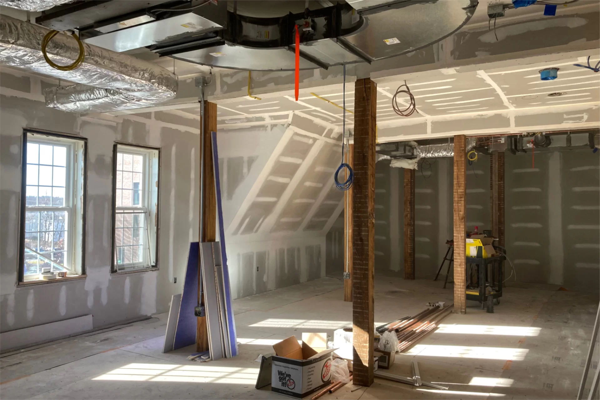 Sheet rock mudded, sanded, and ready for primer in a student lounge on Chase Hall's second floor. (Doug Hubley/Bates College)