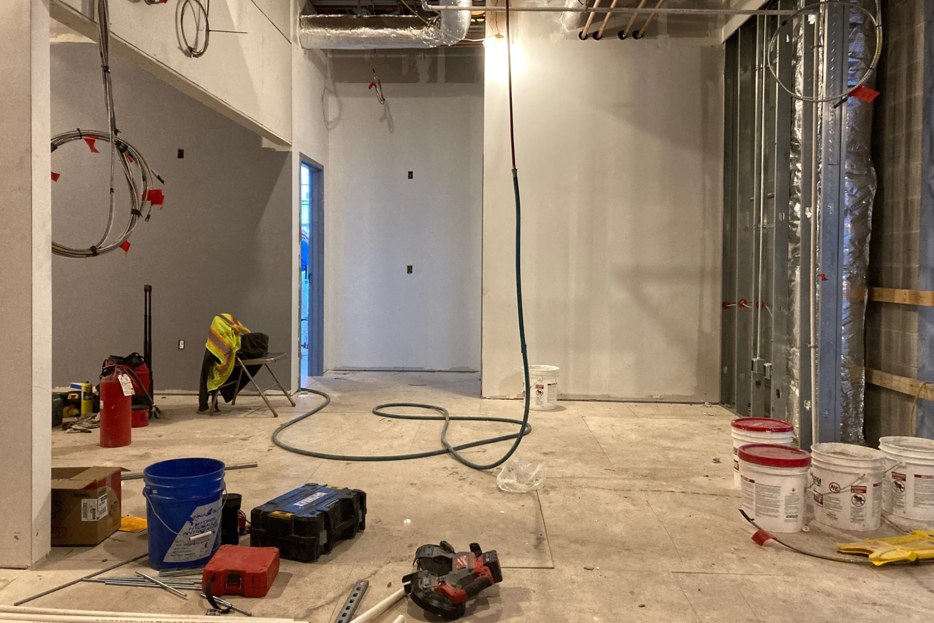 This newly wall-boarded space on Chase Hall’s first floor will be the reception area for the Center for Purposeful Work. Now removed, the stairway that formerly served this floor from Campus Avenue is just out of the frame at right. (Doug Hubley/Bates College)