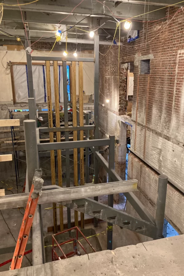 Taken over the guardrail near the edge of a three-story drop, here's a Jan. 11 view of structural steel in the site of the central stair. The wooden verticals will be part of the elevator shaft. The renovation will leave the steel and brick visible, albeit prettied up. (Doug Hubley/Bates College)