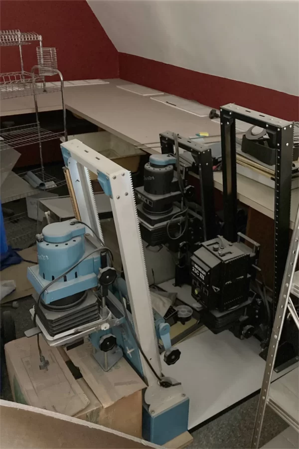 The Chase Hall renovation has had aspects of an archaeological project. Shown are three enlargers, devices used in the days of film photography to make prints. Sizing, focus, and other variables were controlled mechanically. The enlargers are parked for now in the office of the Bates Student newspaper. (Doug Hubley/Bates College)