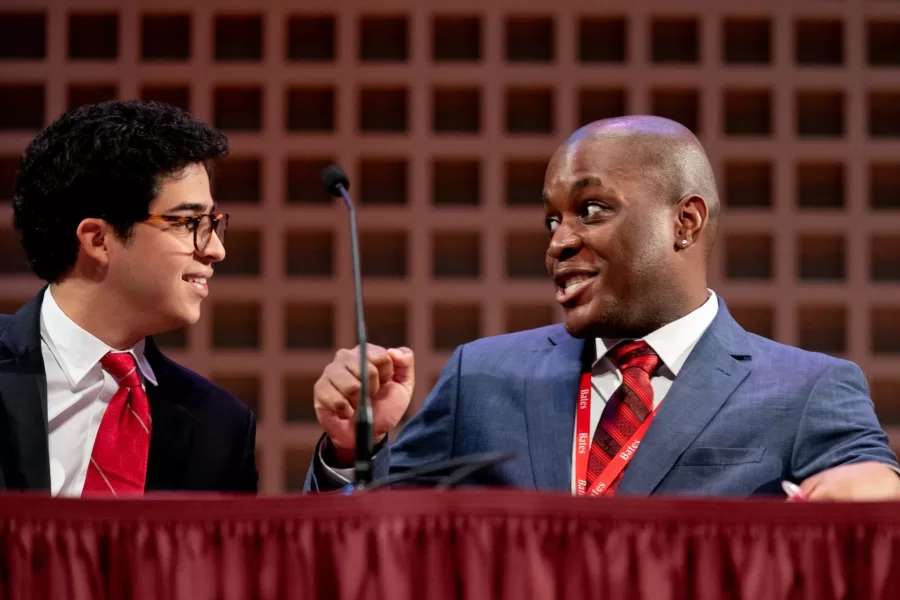 Is it OK to target iconic works of art in the name of social justice? That’s what students from Bates and @morehouse1867 debated at the annual Rev. Dr. Benjamin Elijah Mays, Class of 1920, Debate as part of the college’s Martin Luther King Jr. Day programming. Seen above, Chijindum Dike (left) shares a post-debate celebration with John Curry. Both are students from Morehouse College, and traveled to Bates for the debate. The Bates community and friends crowded into the Olin Arts Center for a much-anticipated part of Bates’ Martin Luther King Jr. Day programming: the debate between four students; two from Morehouse, and two from Bates. The tradition honors Mays, who served as the president of Morehouse College for 27 years. King, then a student at Morehouse, referred to Mays as his “spiritual mentor.” Throughout the debate, the students responded to this year’s motion, “This house believes that the targeting of iconic works of art to advance social justice is justified,” and responded to each other and opinions from the audience. Manuel Machorro ’25 of Mexico City, a politics and philosophy double major, opened the debate on the government side with a quote from Martin Luther King Jr. “Dr. King said ‘if you can’t fly, then run, if you can’t run, then walk, if you can’t walk, then crawl, but by all means, keep moving.’ The claim that we’re gonna make from the government, is that when you’re not listened [to] by anyone, and when the government monopolizes power to destroy you, any way that you see fit is to some capacity justified in pursuing social justice.” Machorro was joined by Dike, a sophomore and double major in psychology and Chinese. The opposition was presented by Curry, a senior and triple major in philosophy, religion, and Chinese, and Andrew Montieth ’24 of Monroe, Wash., a philosophy major. The debaters referenced recent demonstrations, arguing that social justice is furthered by reclaiming spaces and public attention, and the opposition argued that some social activist action diverts attention away from the problem, and onto the targeted object.