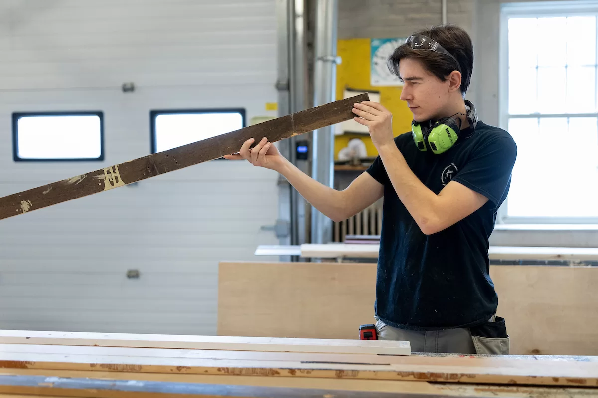 Justin Moriarty, technical Director for Theater and Dance, directs students Natalia Jacobs '26 of Amherst, Mass., (in downstairs shop) and Gideon Berrie '26  of New York City (on the Schaeffer Theatre stage)  in building and painting sets in the shop and on the stage of Schaeffer Theater with the assistance of Aidan McDowell on February 14, 2023.