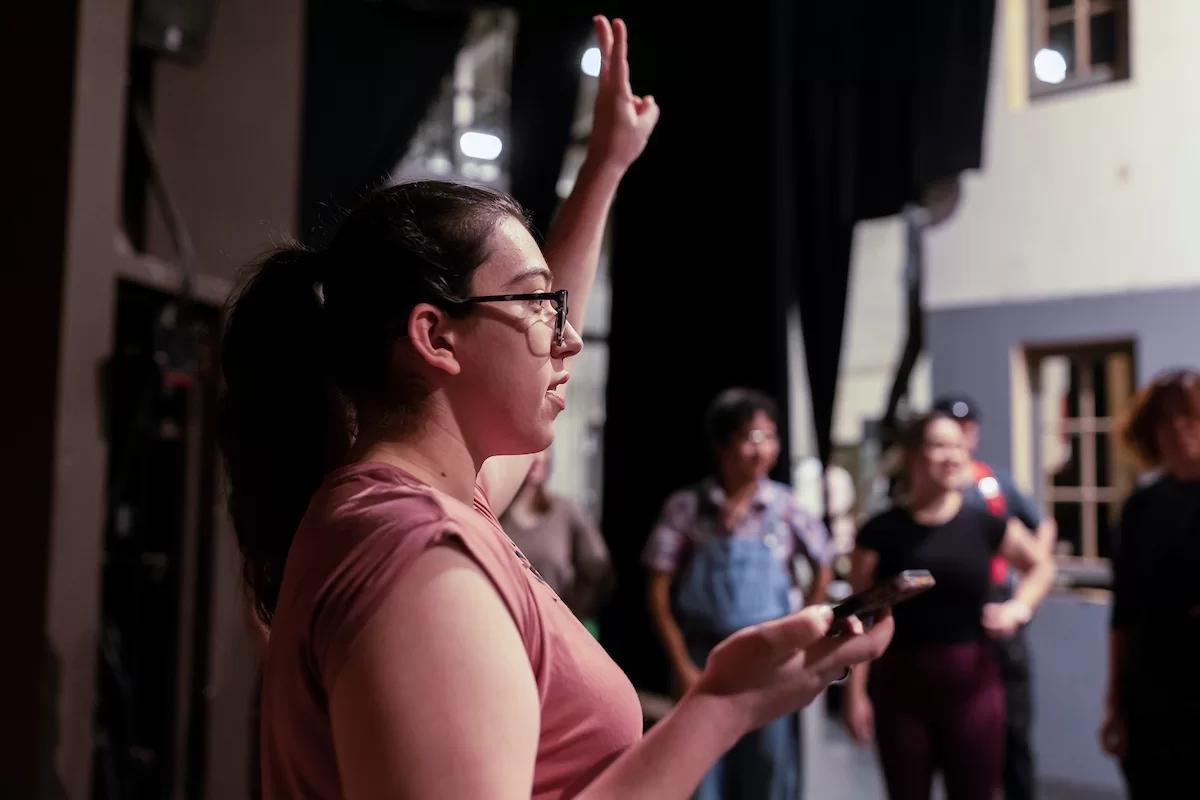 Mia Bernstein 23 of Bedford, Mass., teaches a dance to actors in Shakespeares Much Ado About Nothing directed by Assistant Professor of Theater Tim Dugan on the stage of Schaeffer Theatre on Feb. 16, 2023. Stage Manager Lucie Green 23 of Pittsburgh is also shown in action, seated and moving throughout the theater seats.