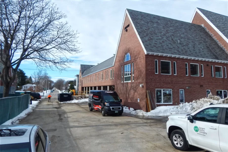 The Chase Hall loading dock is a main entrance for the construction team. Still with their manufacturer labels in place, the lower row of windows at right were recently installed in what will be Student Affairs office space. (Doug Hubley/Bates College)