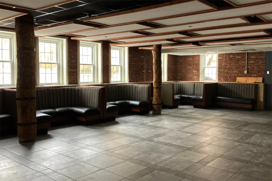 In January, a water main broke behind Chase Hall, sending as much as two inches of water into the Bobcat Den. The booths are shown after they were cleaned. Portable furnishings are stacked in the other end of the dining area, to the right of the image frame. (Doug Hubley/Bates College)