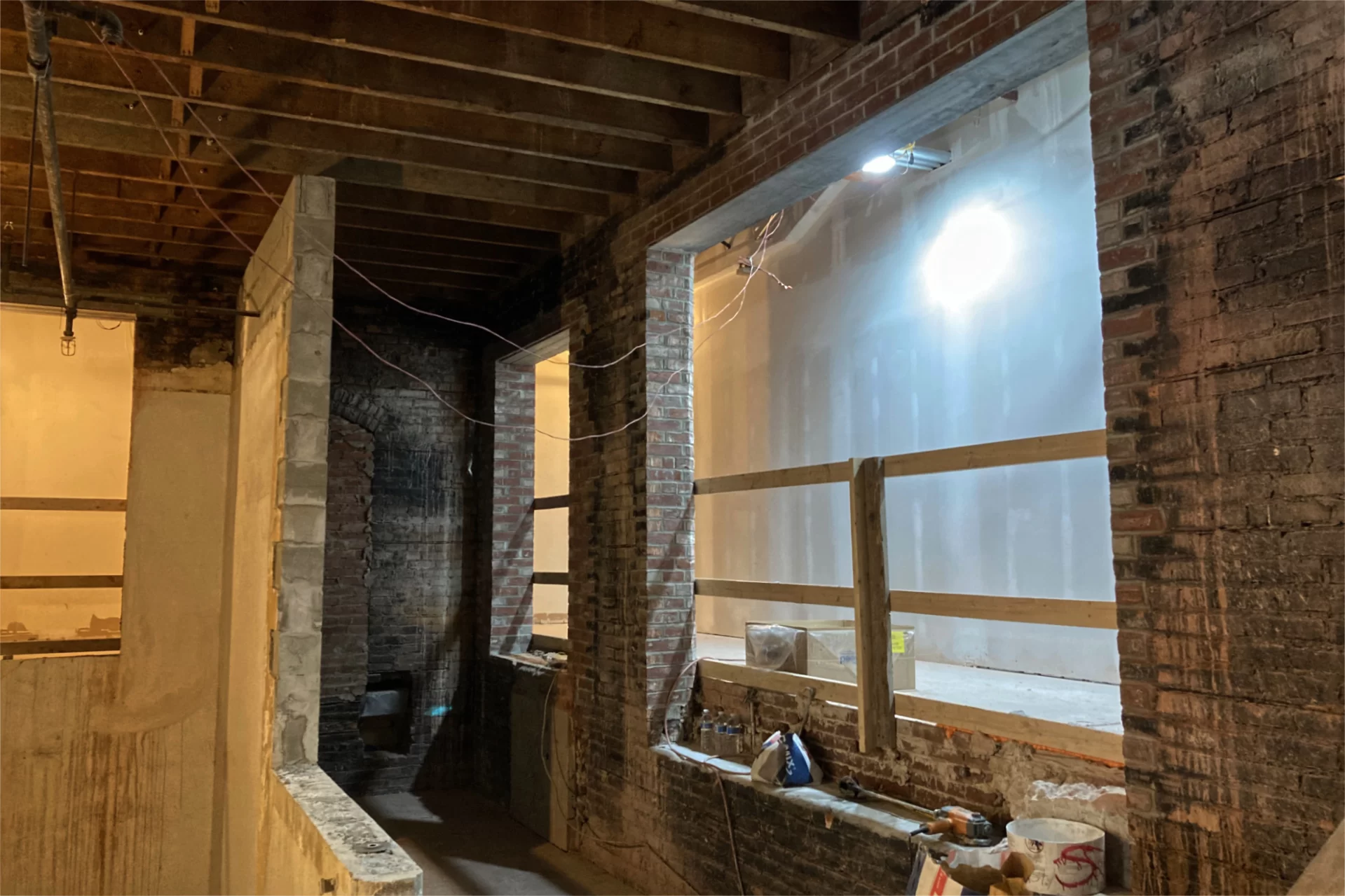 In this section of first-floor Chase lobby, the upper level of floor will be extended leftward to the approximate location of the block half-wall. The "balcony" thus formed will offer a place to sit and watch passing humanity. This is the approximate location of the Chaucer-influenced mural created by art professor Don Lent and his students. (Doug Hubley/Bates College)