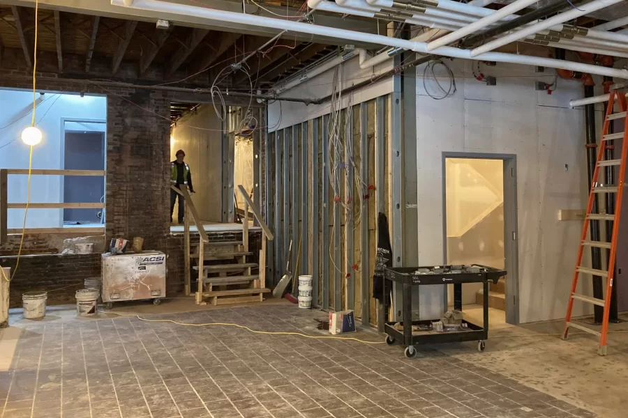 Shown is Chase Hall’s first-floor lobby, with Carnegie Science Hall behind the camera. From left: the forthcoming Overnook, a casual spot to relax; steps and a hallway leading to the central stair; and a new staircase to the second floor. (Doug Hubley/Bates College)