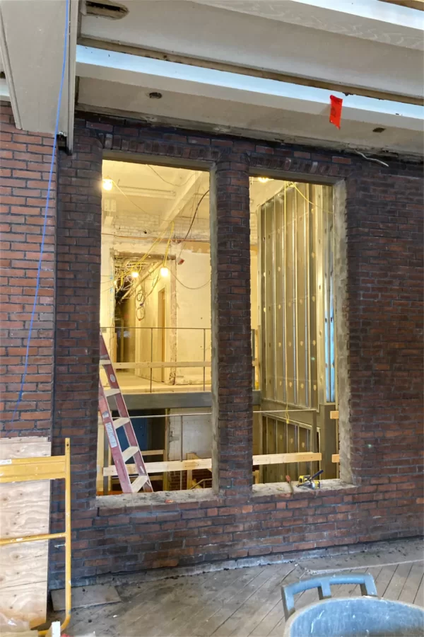 The back wall of Chase Hall Lounge was also the back exterior wall of Chase Hall until a 1978 addition. But now some original windows in that wall have been reopened to admit daylight more deeply into the building. (Doug Hubley/Bates College)