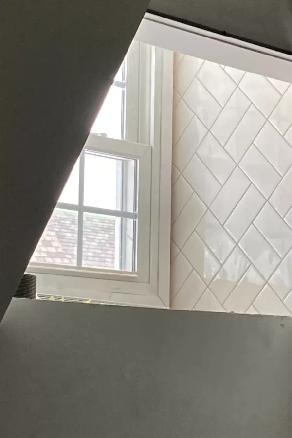 The arrangement of new tiles in a second-floor restroom suits the century-old aesthetic of Chase Hall’s original structure. (Doug Hubley/Bates College)