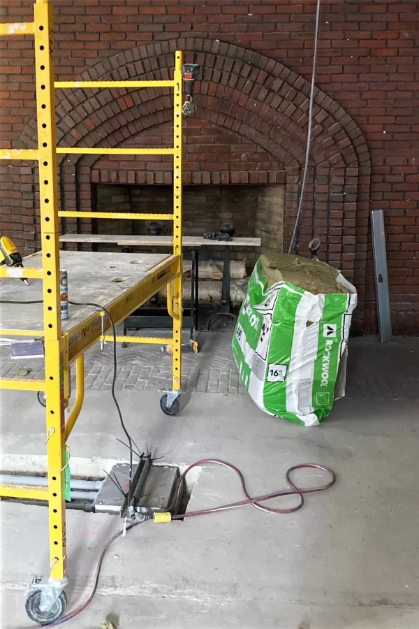 A meeting room is being created around the (non-functioning) fireplace on the ground floor of Chase Hall. (Doug Hubley/Bates College)