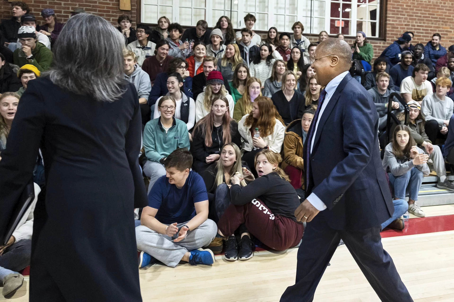 The Bates community meets President-Elect Garry Jenkins at Alumni Gymnasium on March 7, 2022.

President Clayton Spencer, Board of Trustees John Gillespie, Trustee and co-chair of the presidential search Committee Andrea Bueschel and Vice-Chair of the Board of Trustees Jean Wilson, and John Lee, Jenkins’ husband, accompany Jenkins to Alumni Gym, departing from Lane Hall.