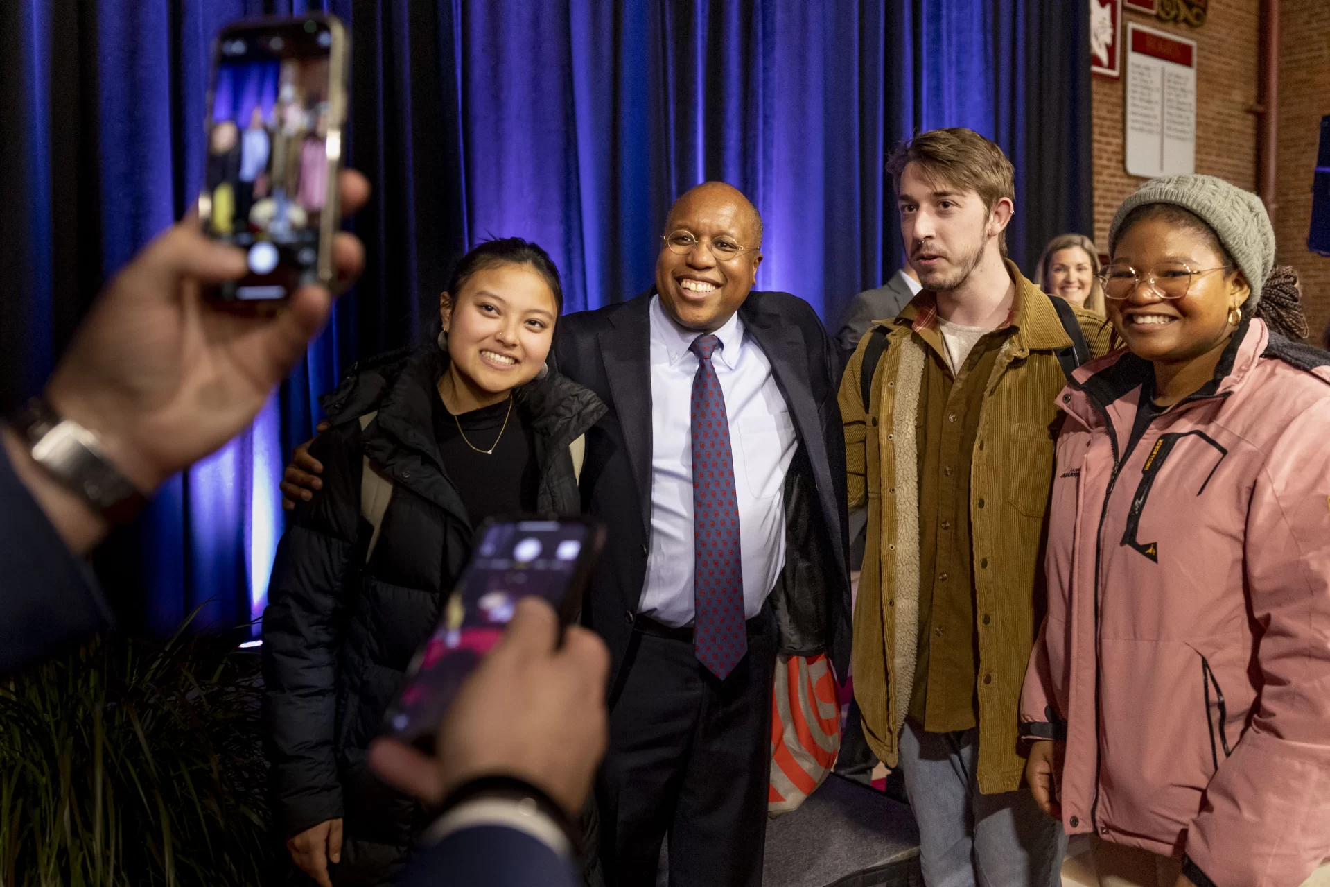 The Bates community meets President-Elect Garry Jenkins at Alumni Gymnasium on March 7, 2022.

President Clayton Spencer, Board of Trustees John Gillespie, Trustee and co-chair of the presidential search Committee Andrea Bueschel and Vice-Chair of the Board of Trustees Jean Wilson, and John Lee, Jenkins’ husband, accompany Jenkins to Alumni Gym, departing from Lane Hall.