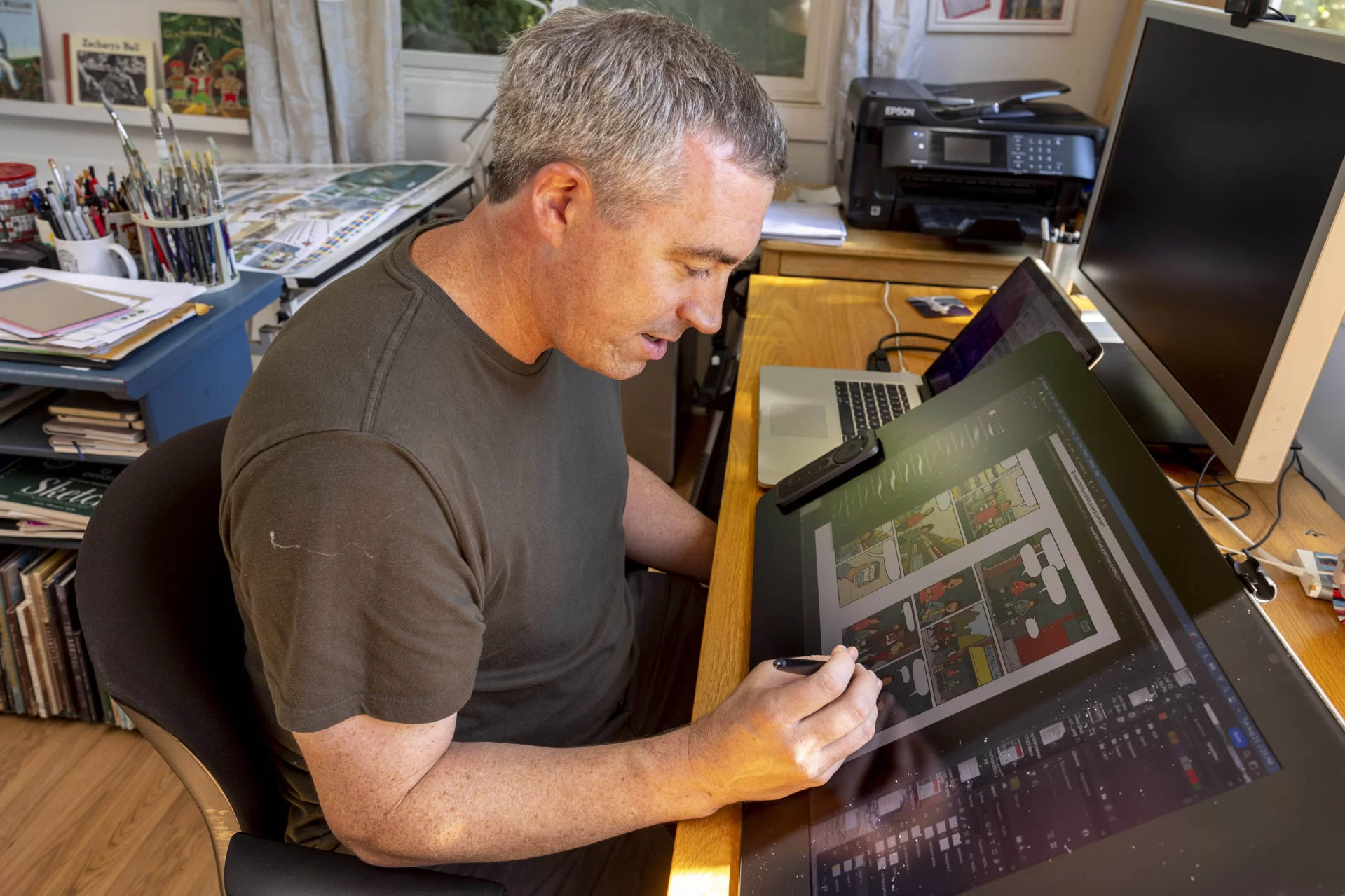 Children’s book illustrator author Matt Tavares ’99 in his Ogunquit, Maine, home and studio as he is interviewed by writer Mary Pols.
Published by Candlewick Press, his first graphic novel, “Hoops” is due out in March, 2023.
Tavares lives in Ogunquit, Maine, grew up in Winchester, Mass., and majored in studio art at Bates. His senior thesis project, a children’s picture book about baseball, later became Tavares’ first book, Zachary’s Ball. Published in 2000 by Candlewick Press, it won the Massachusetts Book Award in 2000 and launched Tavares’ career as an author and illustrator.
