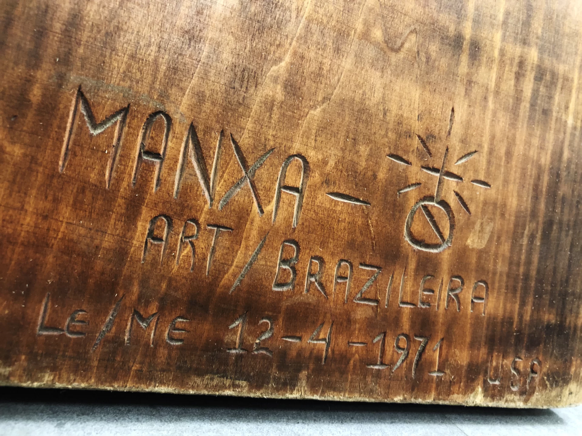 This wood sculpture of Christ on the cross was created by the Brazilian sculptor Ziltamir Sebastião Soares de Maria (1947–2013) (aka "Manxa") who was in residence at Bates in spring 1971 under a program called "Maine's Partners of the Alliance," a culture exchange program then part of USAID and now a private entity called "Partners of the Americas."  

The back of the sculpture has what appears to be its Portuguese title, Auto Retrato Do Meu Povo, or "Self Portrait of My People" 

Size: 7 feet tall and 5 feet 8 inches wide

When Created: The back has written March 5, 1971, with a dollar figure (a price estimate for a potential sale?) also written ($800).

Inscription at Top: “INRI,” Latin for “Jesus, King of the Jews,” commonly seen on crucifixes. 

The sculpture was stored by Facility Services for years, and was photographed in the BCO offices In Lane Hall