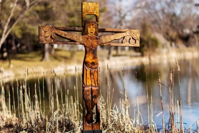What: Wood sculpture of Christ on the cross Created by: The Brazilian sculptor Ziltamir Sebastião Soares de Maria (1947–2013) (aka "Manxa") was in residence at Bates in spring 1971 under a program called "Maine's Partners of the Alliance," a culture exchange program then part of USAID and now a private entity called "Partners of the Americas." Name: The back of the sculpture, which is, has what appears to be its Portuguese title, Auto Retrato Do Meu Povo, (“OWtoh hrayTRAtoh doh MEI-oh POvoh”, roll the “r”s in retrato) or "Self Portrait of My People" Size: 7 feet tall and 5 feet 8 inches wide When Created: The back has written March 5, 1971, with a dollar figure (a price estimate for a potential sale?) also written ($800). Inscription at Top: “INRI,” Latin for “Jesus, King of the Jews,” commonly seen on crucifixes. Fruit: The fruit that Jesus grasps could reflect Manxa’s style of indiginous Brazilian art. He “carved in wood... sometimes with spaces in copper inlays, characters, crafts and all tropical flora of Rio Grande do Norte,” his home state in Brazil.