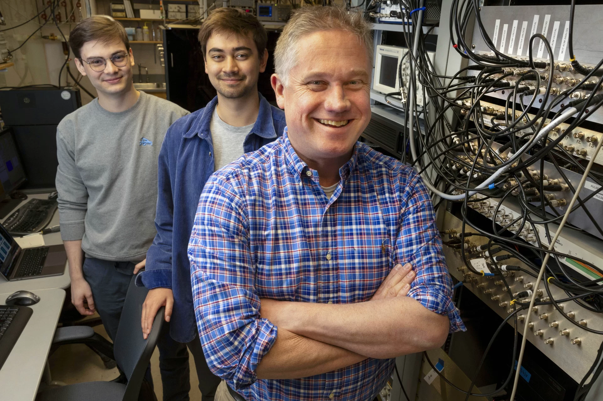 Professor of Physics Nathan Lundblad has received an award from NASA. He is collaborating with several students on the research and is shown here in his Carnegie Science Lab (Carnegie 146) with two of those students, Kona Lindsey ’23 of Colorado Springs, Colo., and Elias Veilleux ’23 (I gray shirt with glasses) of Orono, Maine

Kona is shown with his laptop that display research images. Kona writes: “The image seen on my laptop is from an experiment run in the Cold Atom Lab on the International Space Station (ISS). It shows an ultracold gas bubble composed of rubidium atoms. The ring that is visible indicates that the atoms are occupying a shell, or bubble structure. You can see that the inside of the ring has few atoms, meaning the structure is truly hollow.”