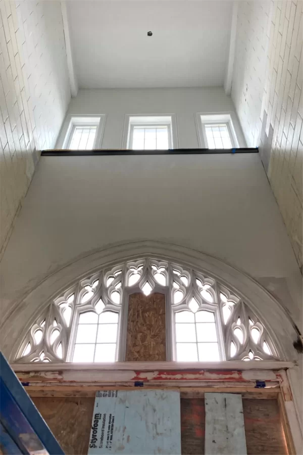 Even on a rainy April day, daylight floods the three-story "light well" — formerly a stairwell — enclosing Chase Hall’s main Campus Avenue entrance. (Doug Hubley/Bates College)