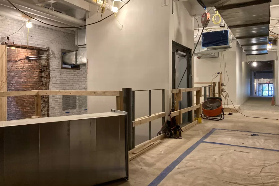 This view of the central stair area shows the new elevator at center and, at right, the corridor leading to Chase Hall’s Overnook and first-floor lobby. The opening at left looks into Chase Hall Lounge. (Doug Hubley/Bates College)