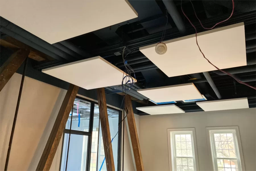 The combination of blue-gray paint and suspended-tile "clouds" on the ceiling, ample natural light, and exposed wooden trusses makes this Purposeful Work office most attractive. (Doug Hubley/Bates College)