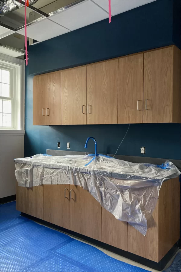 Cabinets and a sink have been installed in a kitchenette on Chase Hall’s second floor. (Doug Hubley/Bates College)