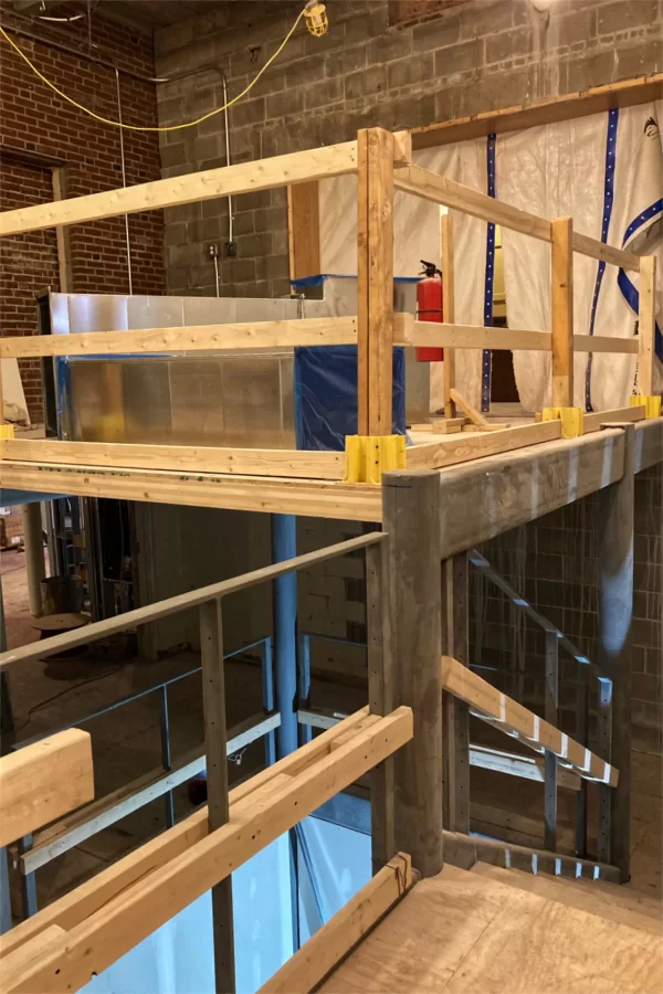 Shown are three of the four Chase Hall levels linked by the central stair. At top is the reception area for the Office of Intercultural Education, which will be enclosed in glass. (Doug Hubley/Bates College)