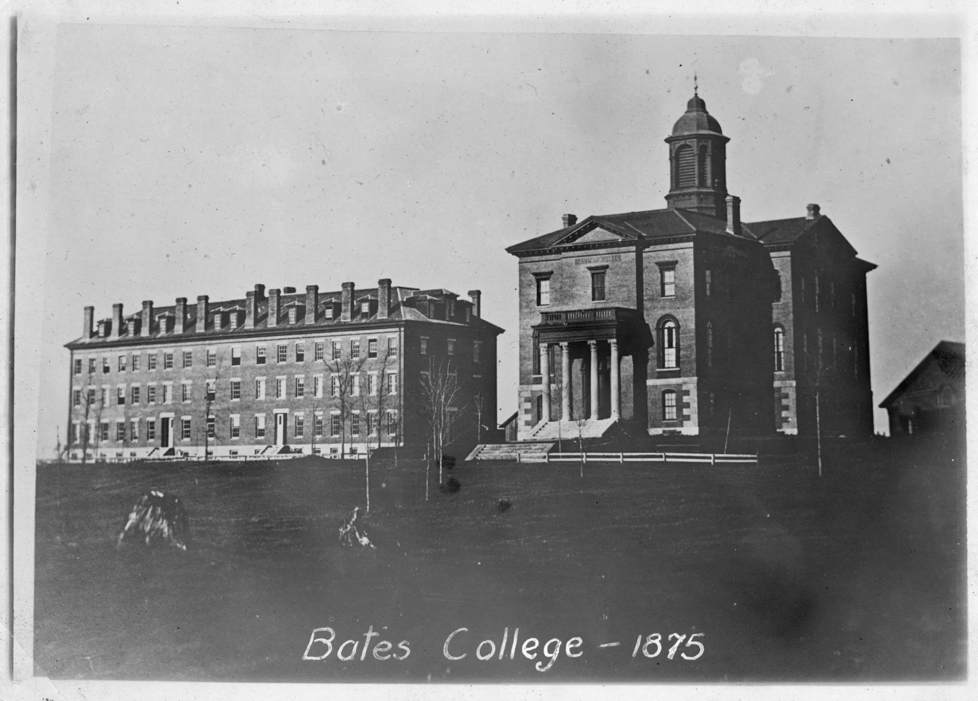 Shown are Hathorn and Parker halls c. 1875, not even 20 years after the buildings were constructed. What we now call the Historic Quad has a more minimalist appeal in this photo. Note the louvers enclosing Hathorn’s bell tower and the absence of the now-familiar clock on the front porch. (Edmund S. Muskie Archives and Special Collections Library)