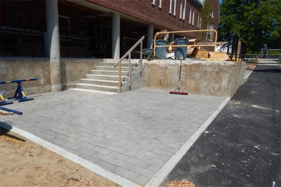New asphalt pavers have been laid on both sides of the former Chase Hall loading dock, which will be spruced up for use as a patio. (Doug Hubley/Bates College)