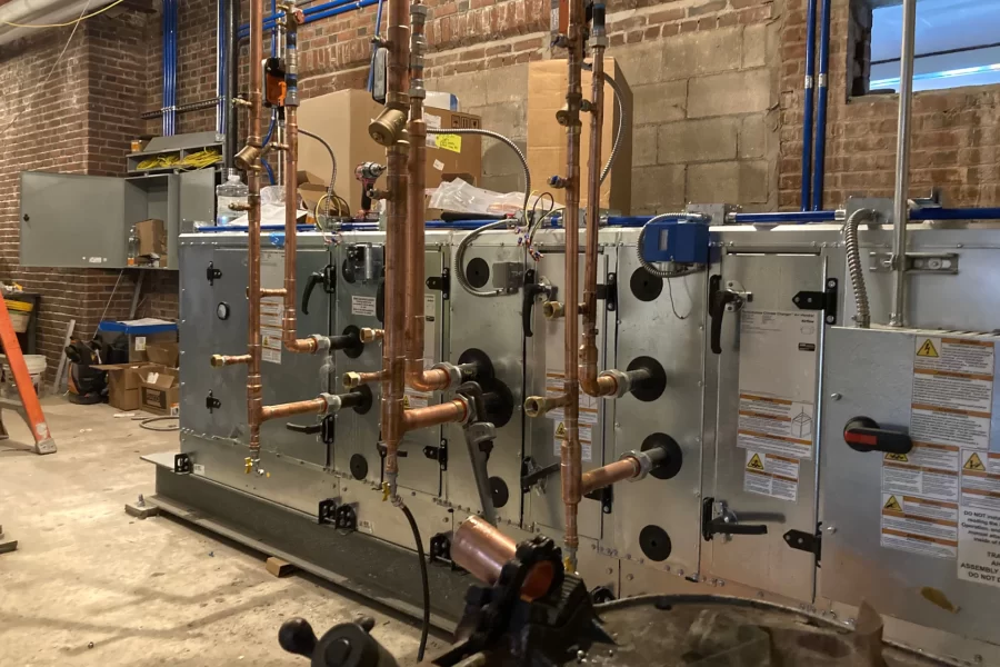 Chase Hall’s new air handling machine. It shares a new mechanical room on the first floor with an energy recovery ventilator. (Doug Hubley/Bates College)