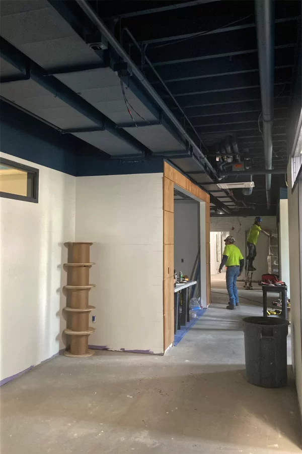 A view through the new Student Life office suite, located in the former site of the College Store. Note the new wood trim framing the meeting room at center — a space that houses a fireplace original to century-old Chase Hall. (Doug Hubley/Bates College)