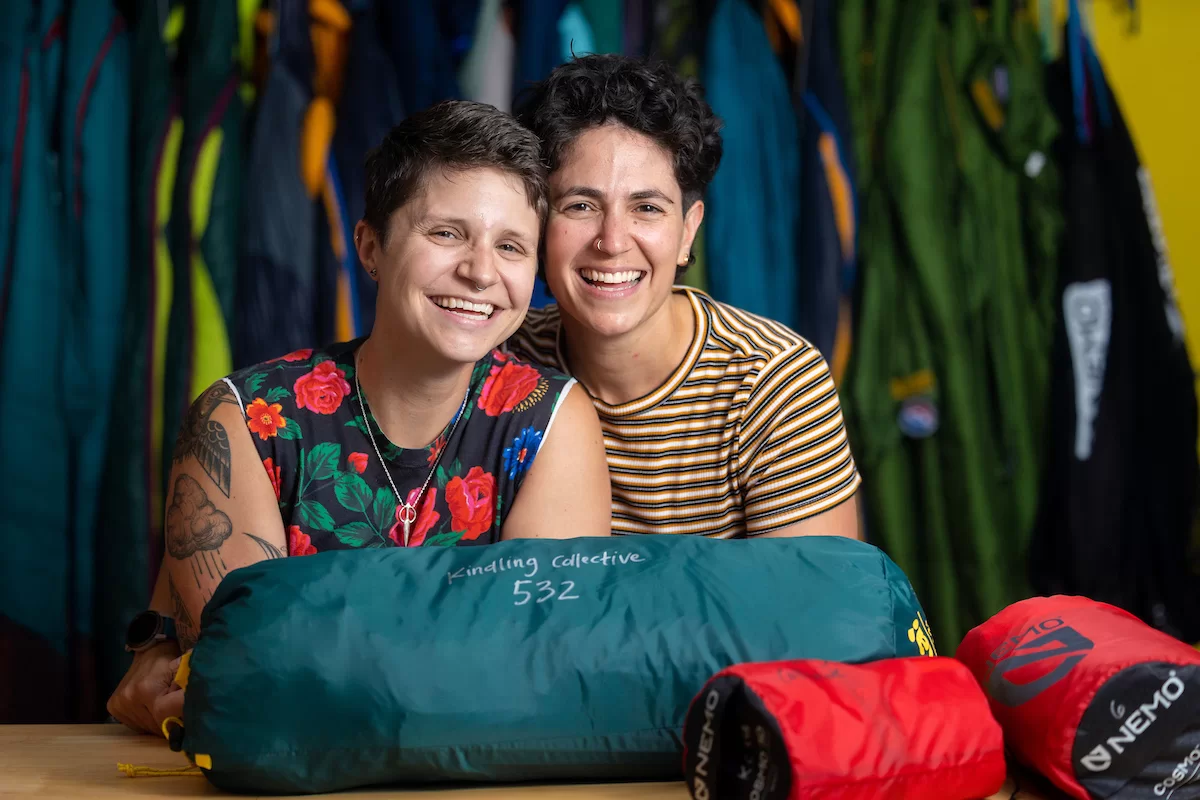 In the basement of Portland’s Equality Community Center, Portland’s newest gear library lacks the store-front appeal of the many outdoor retail shops in a state famous for its outdoor recreation. But one step inside Kindling Collective during its open house on June 10 and the orange and pink walls, the sound of laughter, and the mini outdoor-gear lessons breaking out spoke of a warm, welcoming community and, most of all: joy.

Kindling Collective, a gear library focused on the queer community, was founded this spring by business partners, spouses and outdoor enthusiasts Hallie Herz ‘11 (wearing striped shirt) and Eva Fury in an effort to help the LGBTQ+ community access the outdoors in a safe, fulfilling and affordable way. 

The tiny 400-square-foot space welcome everyone, though it's focused on helping queer people specifically feel welcome, empowered and inspired. Focusing on joy, Hertz said, is central to their mission.

Herz and Fury were photographed at 15 Casco St. on June 15, 2023.