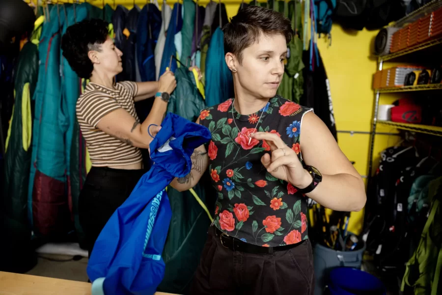 In the basement of Portland’s Equality Community Center, Portland’s newest gear library lacks the store-front appeal of the many outdoor retail shops in a state famous for its outdoor recreation. But one step inside Kindling Collective during its open house on June 10 and the orange and pink walls, the sound of laughter, and the mini outdoor-gear lessons breaking out spoke of a warm, welcoming community and, most of all: joy.

Kindling Collective, a gear library focused on the queer community, was founded this spring by business partners, spouses and outdoor enthusiasts Hallie Herz ‘11 (wearing striped shirt) and Eva Fury in an effort to help the LGBTQ+ community access the outdoors in a safe, fulfilling and affordable way. 

The tiny 400-square-foot space welcome everyone, though it's focused on helping queer people specifically feel welcome, empowered and inspired. Focusing on joy, Hertz said, is central to their mission.

Hertz and Fury were photographed at 15 Casco St. on June 15, 2023.