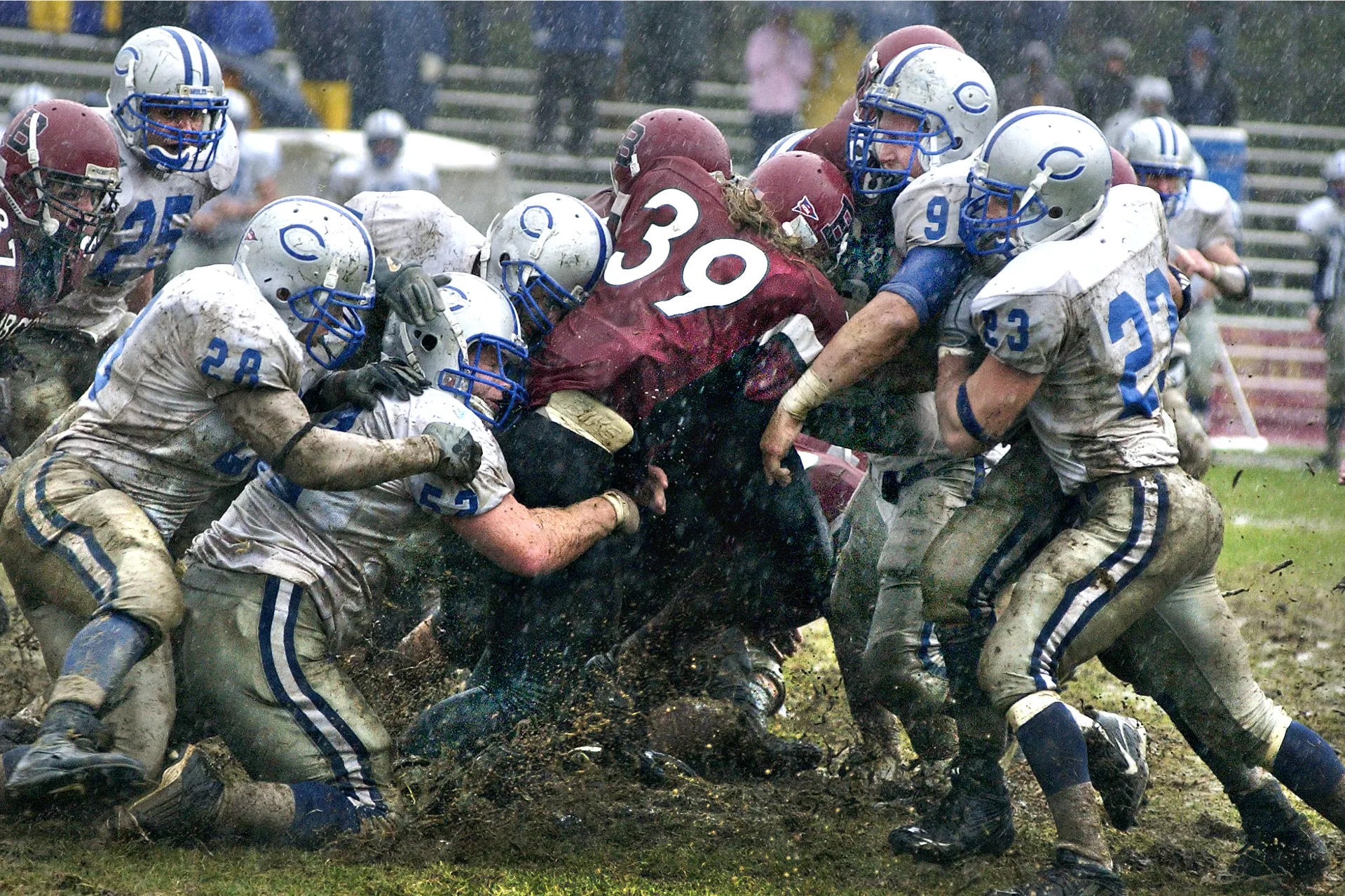 Four years before the advent of artifical turf on Garcelon Field, this image of Jamie Walker ’07 of Needham, Mass., moving a pile of Colby defenders during a game in October 2006 later appeared in Sports Illustrated. (Daryn Slover for Bates College)