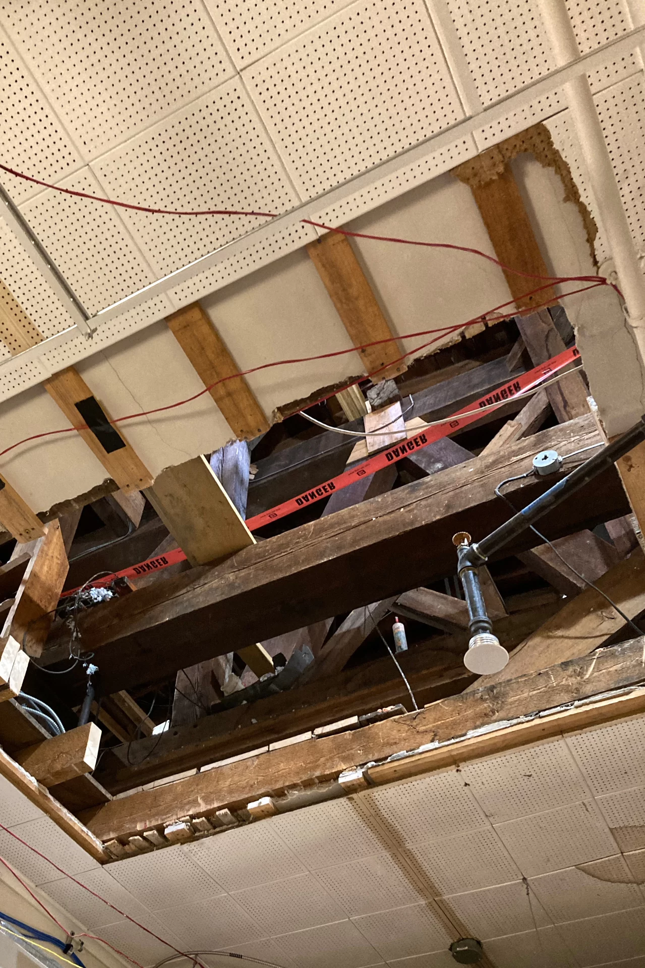 This opening in a third-floor ceiling in Hathorn Hall will eventually house a retractable stairway providing access to the attic. Before that’s installed, though, HVAC machines will be swapped out through the hole. (Doug Hubley/Bates College)