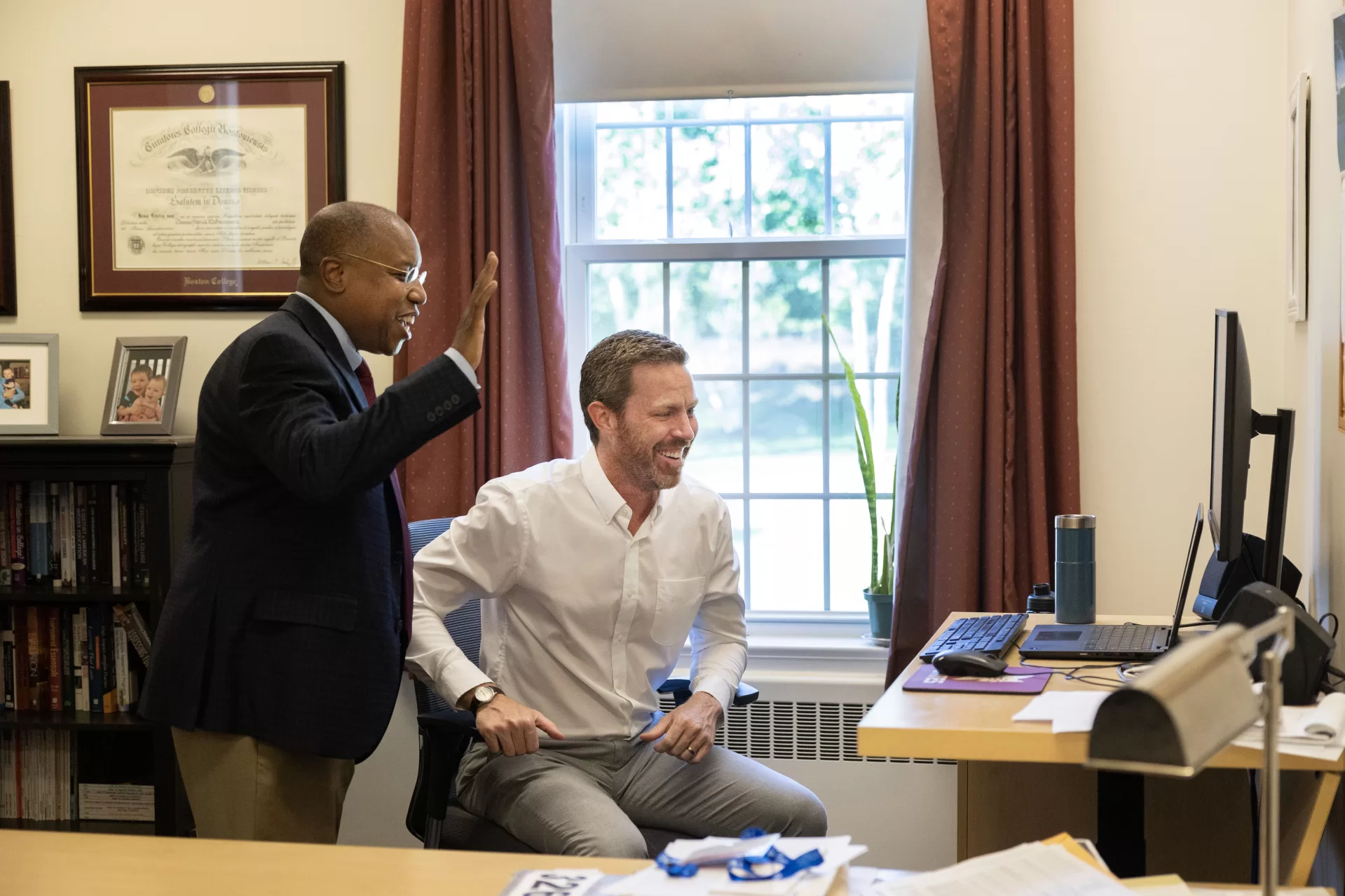 President Garry Jenkins greets employee in Lane Hall, where he has an office on the second floor.

Day Five for the ninth Bates president — who officially became president on July 1 — was anything but a 9-to-5 affair, but instead a chance to explore the campus and meet as many folks as possible. After an early-morning walkthrough of Lane Hall, where he has his office, and the beverage break, provided by our Curb Cats food truck team, Jenkins took his first meal in Commons, a working lunch with faculty who are leading a few different academic initiatives.