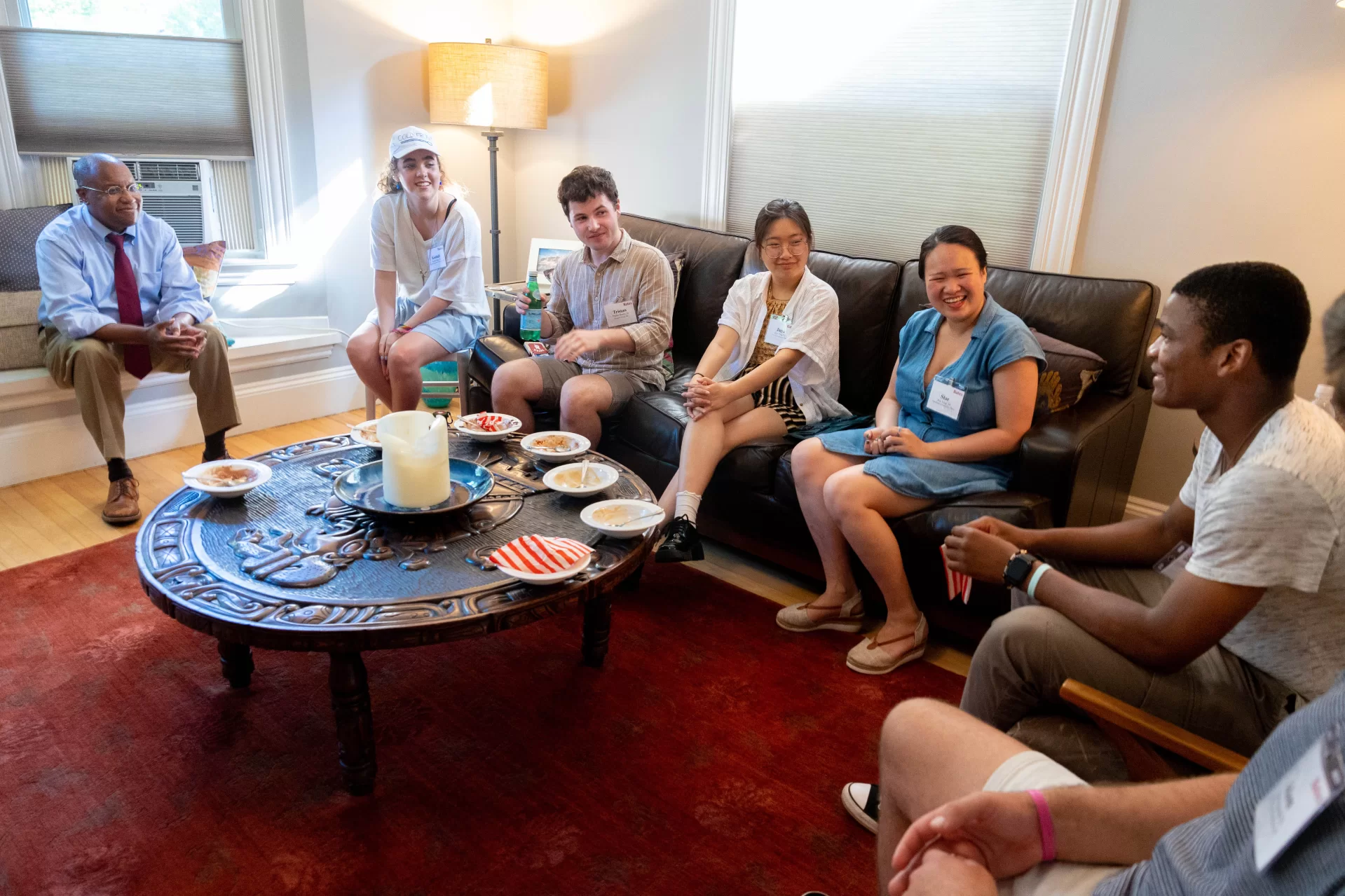 President Garry Jenkins meets with Admission Fellows for an ice cream social at the home of Vice President for Student Life Josh McIntosh at his home on 36 Mountain Avenue on July 5, 2023. It was the last scheduled event of the day. Day Five for the ninth Bates president — who officially became president on July 1 — was anything but a 9-to-5 affair, but instead a chance to explore the campus and meet as many folks as possible. After an early-morning walkthrough of Lane Hall, where he has his office, and the beverage break, provided by our Curb Cats food truck team, Jenkins took his first meal in Commons, a working lunch with faculty who are leading a few different academic initiatives. The afternoon was spent touring a variety of academic spaces and getting an inside look at the nearly completed Chase Hall renovation. His day concluded with a reception with colleagues and students who are on campus working as Admission fellows.