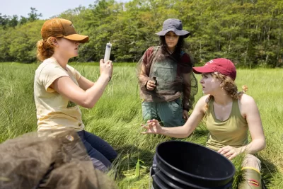 Professor of Earth and Climate Sciences Beverly Johnson takes her summer research students who are studying blue carbon cycling in salt marshes to Bates-MorseM ountain in Phippsburg.