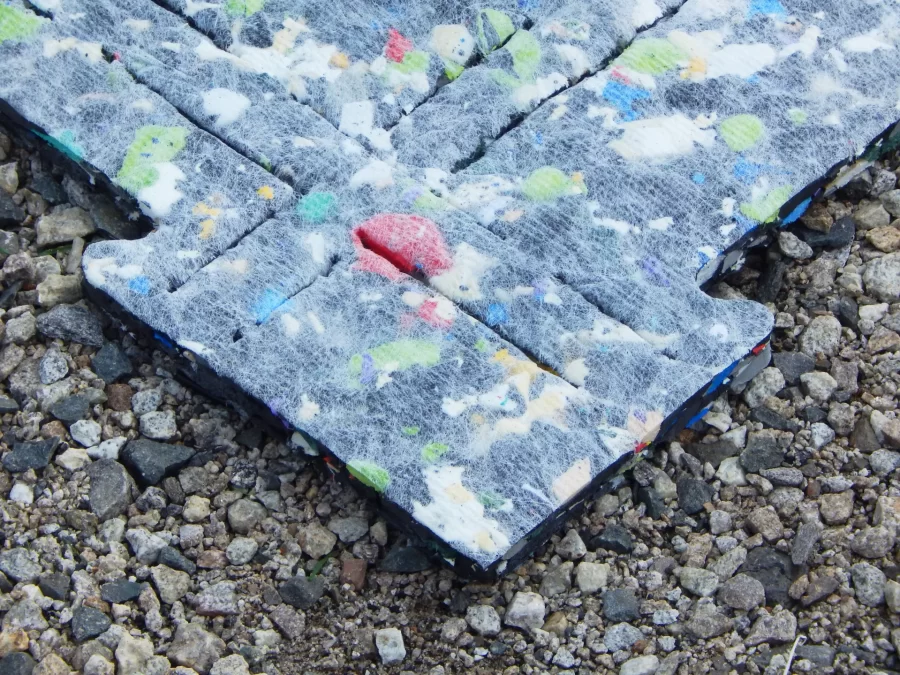 The turf pads that form a shock-absorbing layer underneath the Garcelon playing surface are made from recycled materials. (Doug Hubley/Bates College)