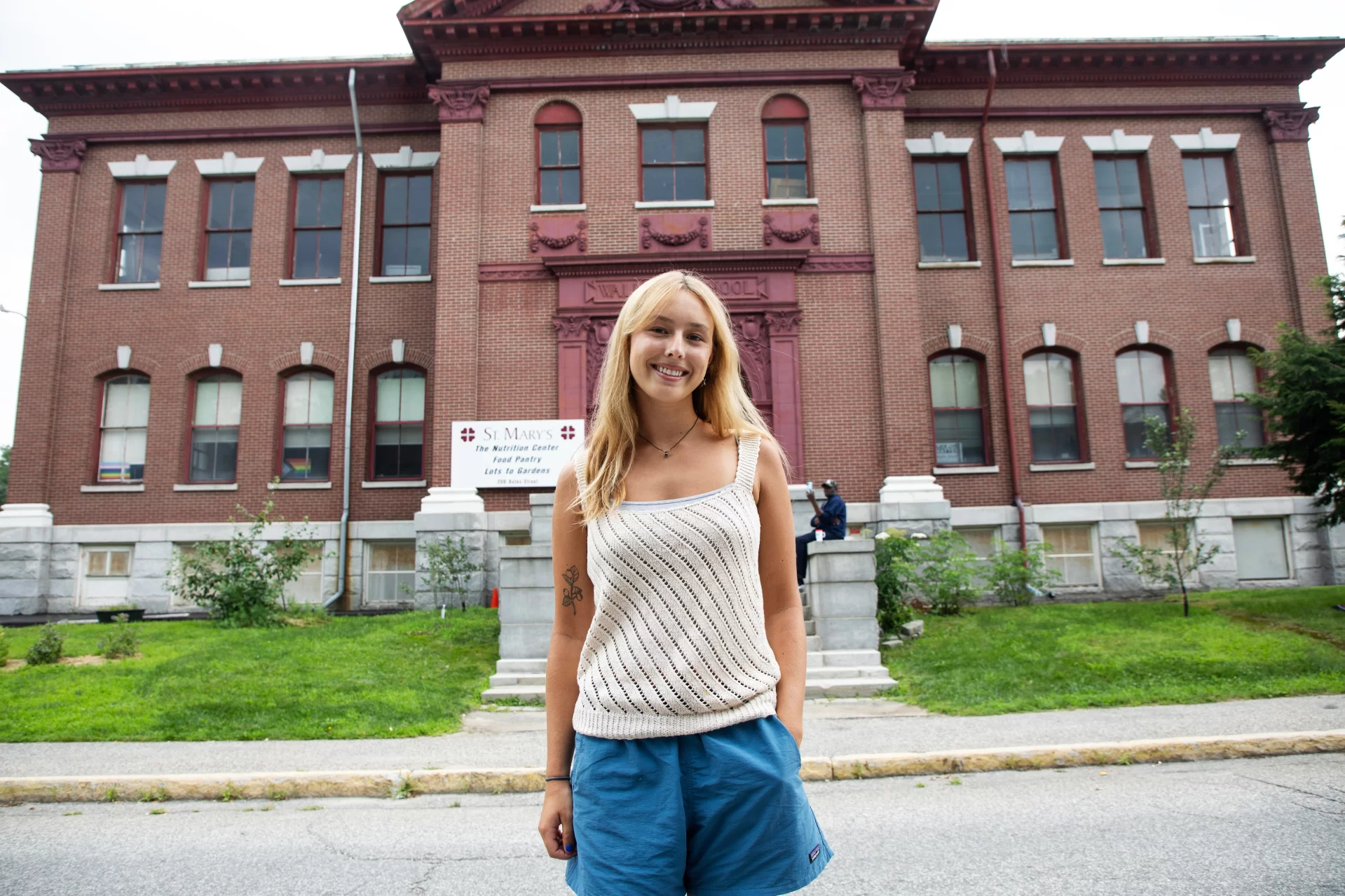 Naomi Lynch ‘25 of Farmingdale, Maine, Environmental Sciences, poses for a portrait outside St. Mary's Nutrition Center on July 19, 2023.

(Theophil Syslo | Bates College)