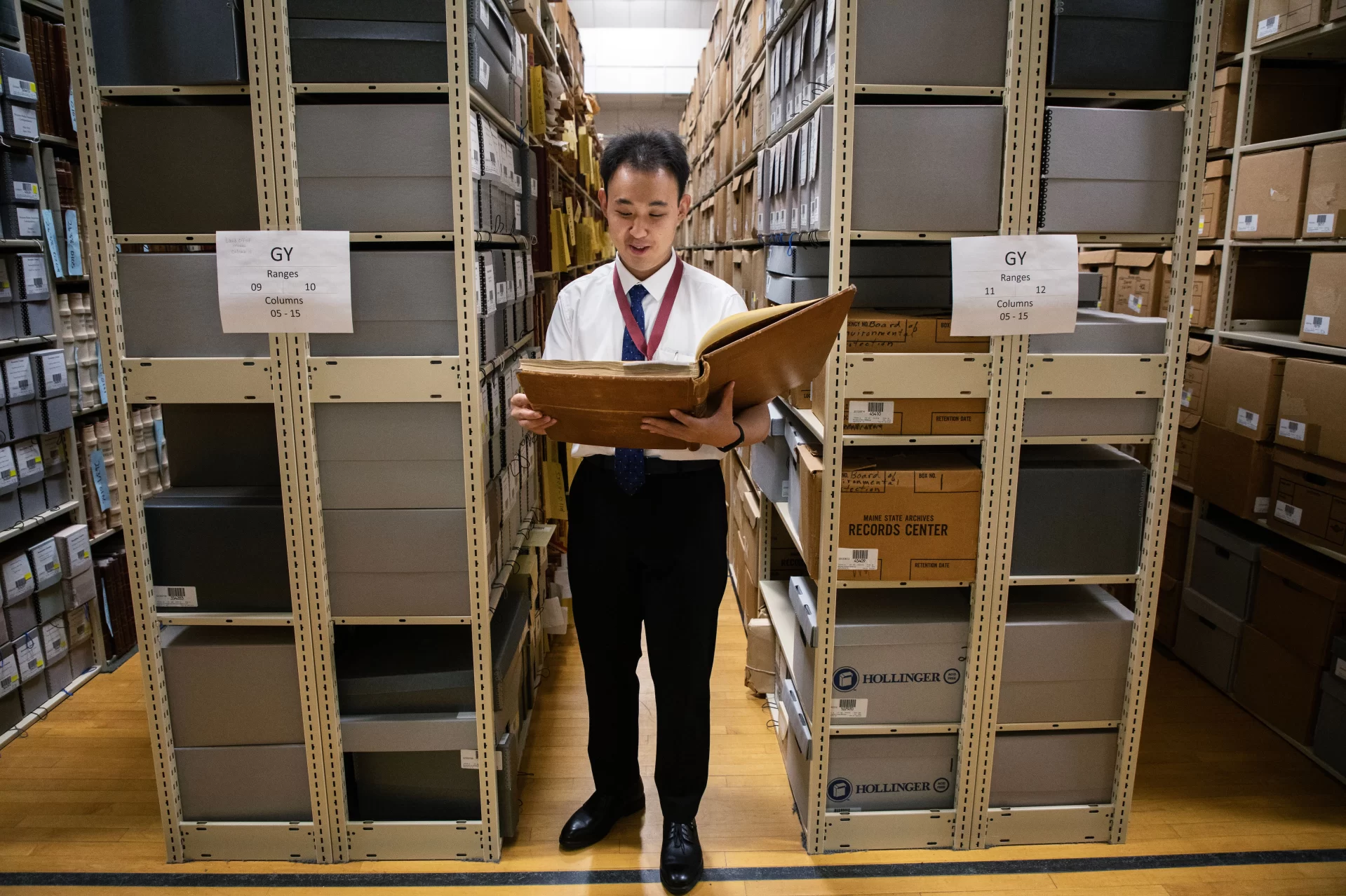Alan Wang ‘24 of China, poses for a portrait at the Maine State Archives on July 20, 2023.

Portraits were shot at The Maine State Archives temporary offices while the Maine State Cultural Building is renovated. (Theophil Syslo | Bates College)