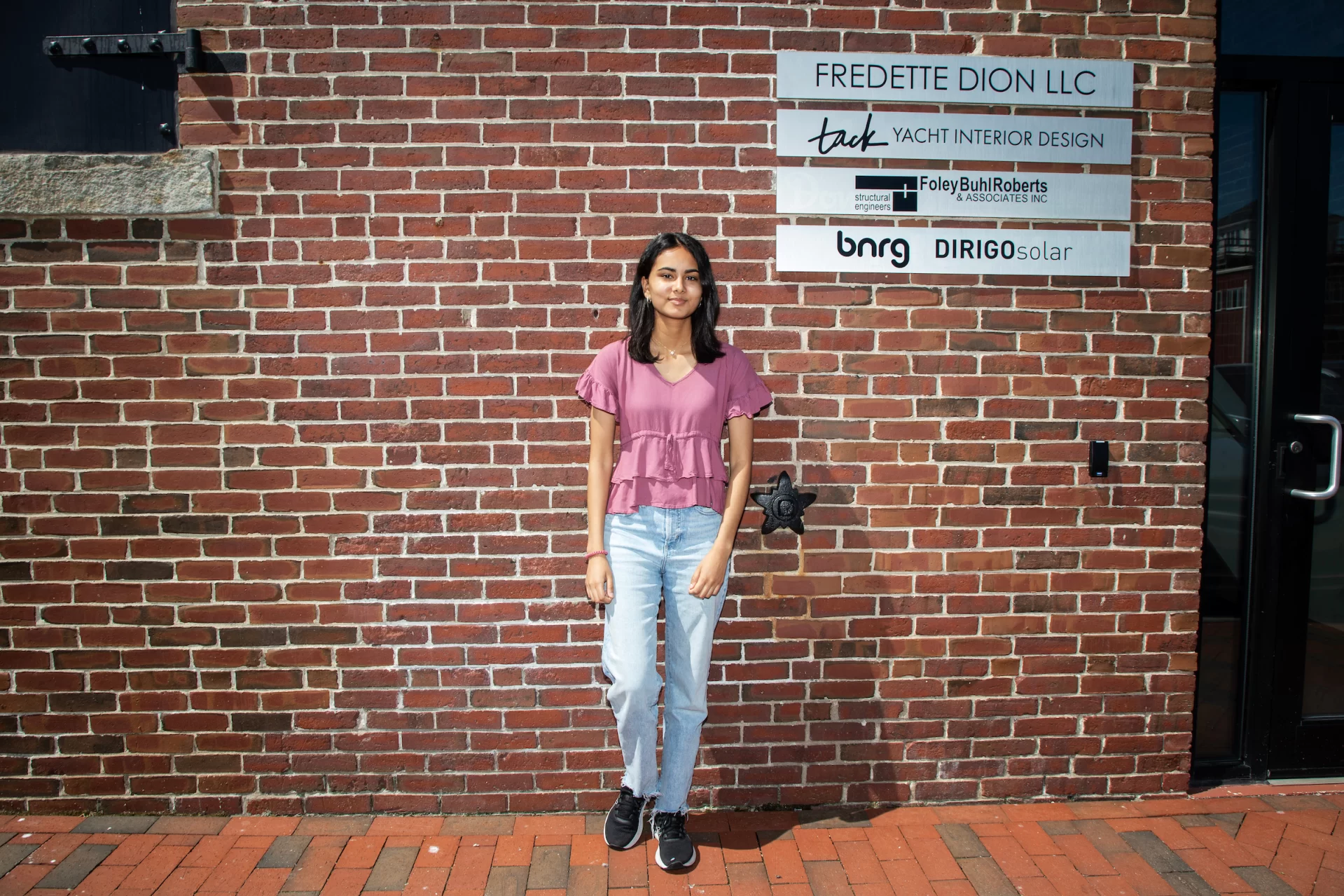 Aneeza Ahmad ‘25 of Sharon, Mass., poses for a portrait in front of Dirigo Solar in Portland Maine on July 20, 2023. (Theophil Syslo | Bates College)